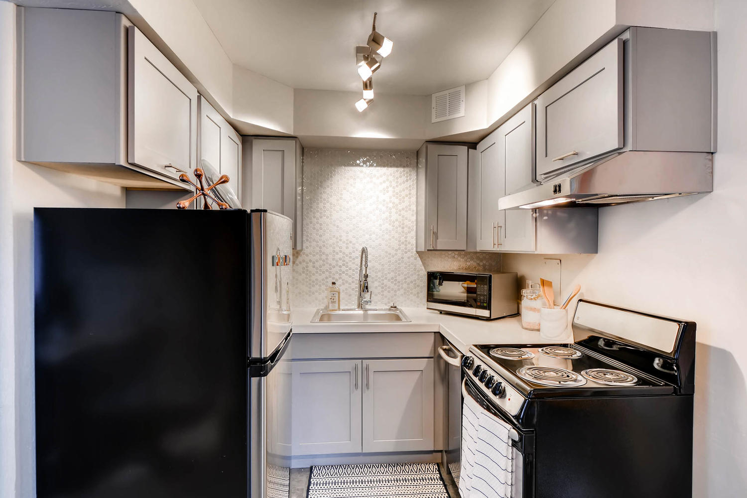 Kitchen with stainless steel appliances and tile backsplash