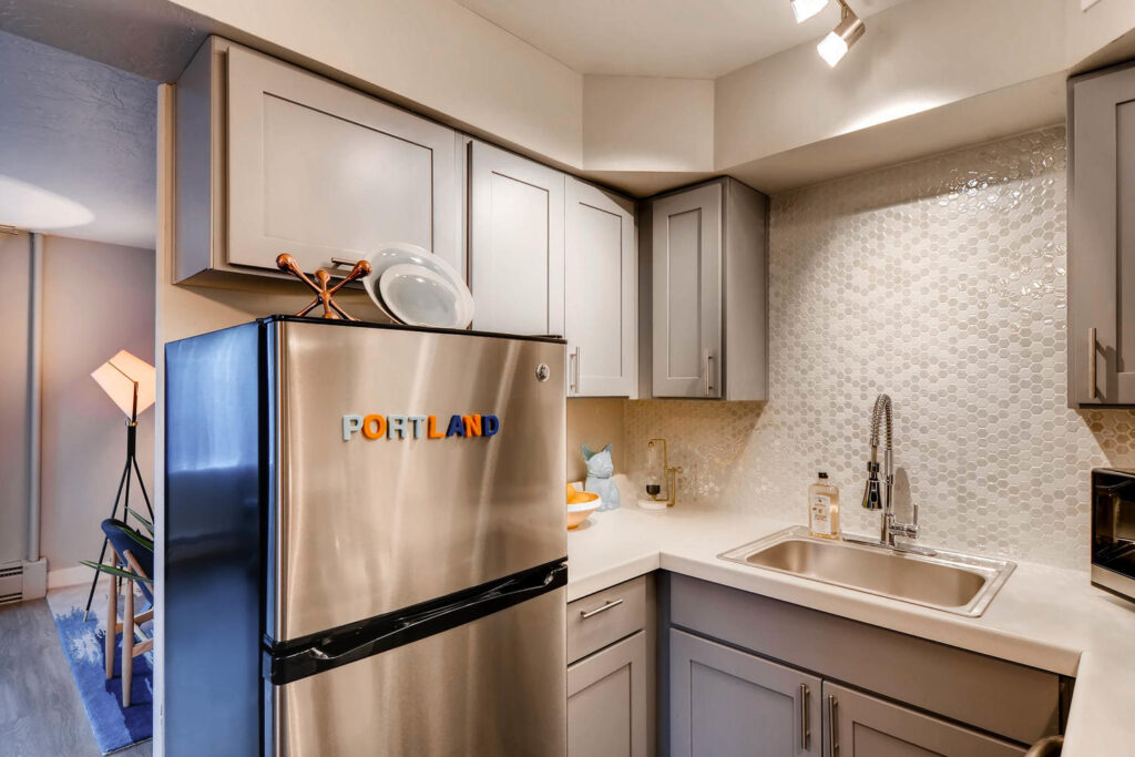 Kitchen with stainless steel appliances and tile backsplash