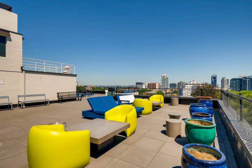 Rooftop with city skyline views, deck seating, outdoor games