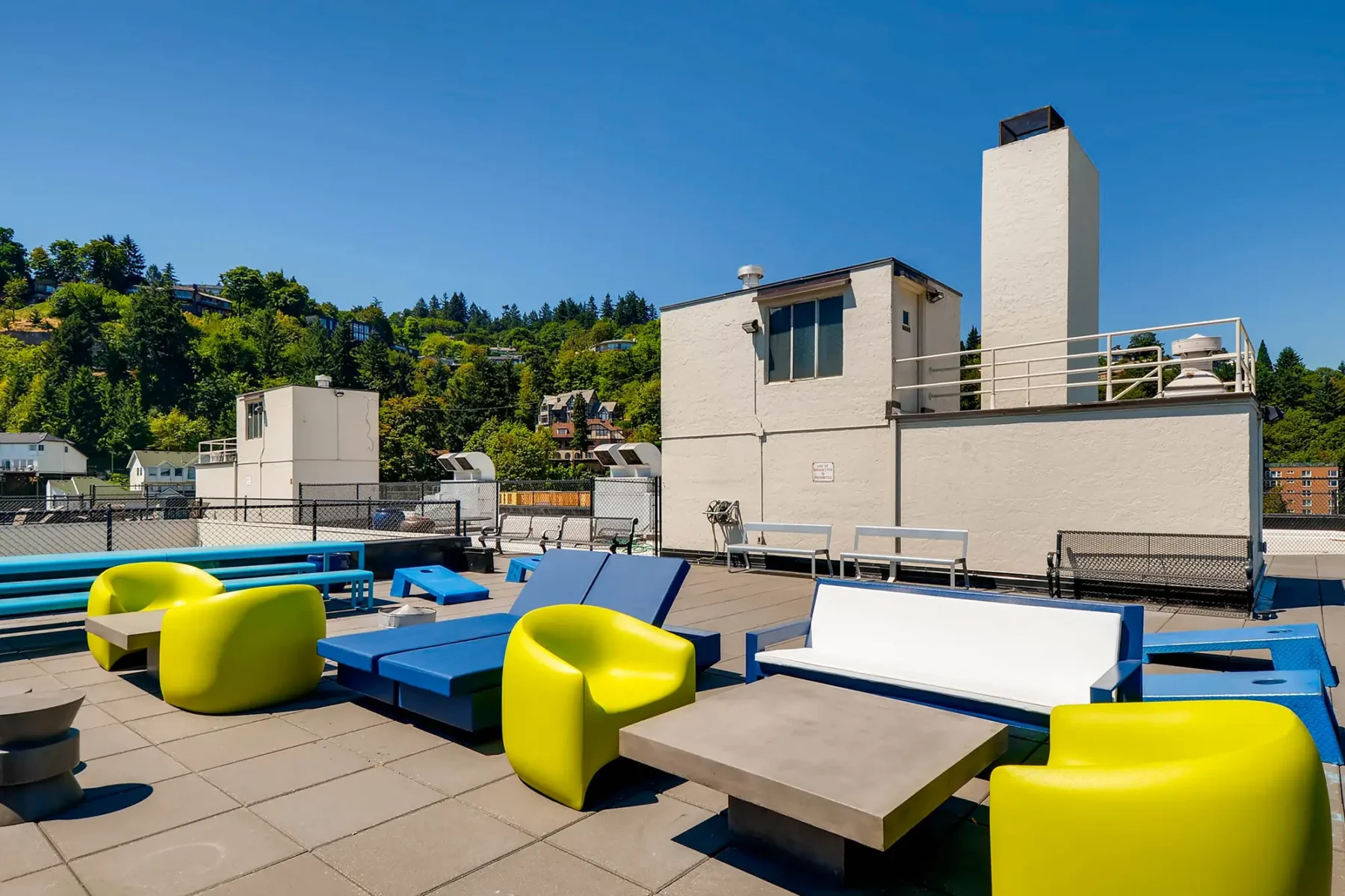 Rooftop with city skyline views, deck seating, outdoor games