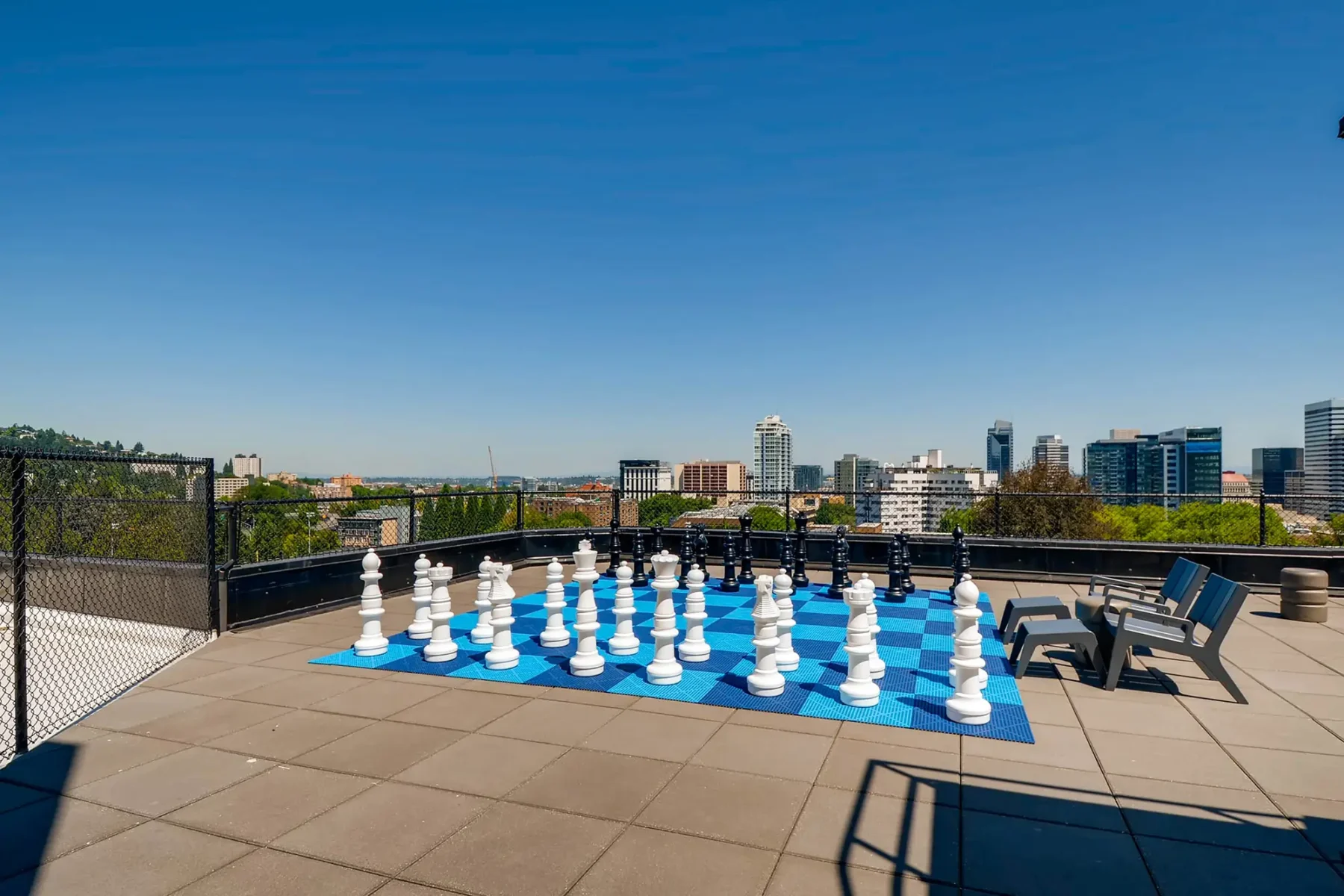 Rooftop with city skyline views, giant chess set