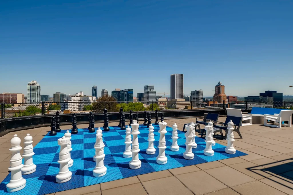 Rooftop with city skyline views, giant chess set