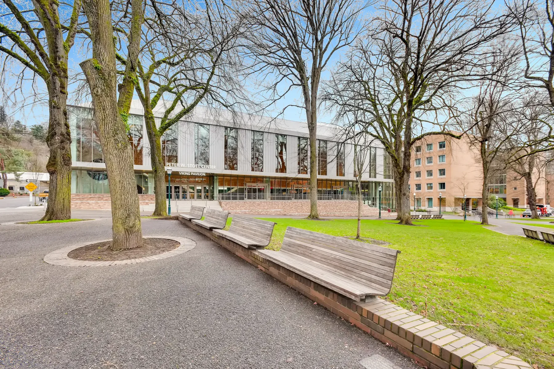 Public park with green space and benches outside the Peter W. Scott center